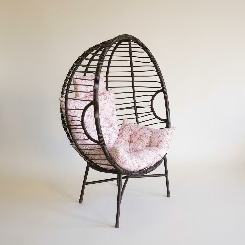 Gardenia Furniture Venicia egg-shaped rattan chair with pink floral cushions, suitable for indoor/outdoor use.