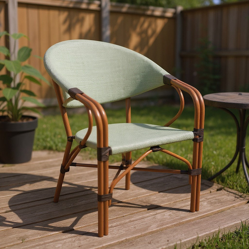Gardenia Furniture RiO chair with light olive green PVC mesh fabric seat and back, rattan frame, and caramel brown metal accents. Ideal for outdoor spaces.