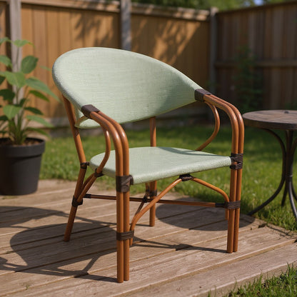 Gardenia Furniture RiO chair with light olive green PVC mesh fabric seat and back, rattan frame, and caramel brown metal accents. Ideal for outdoor spaces.